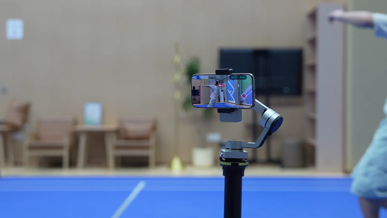 A phone on Tribot's gimbal following a badminton player