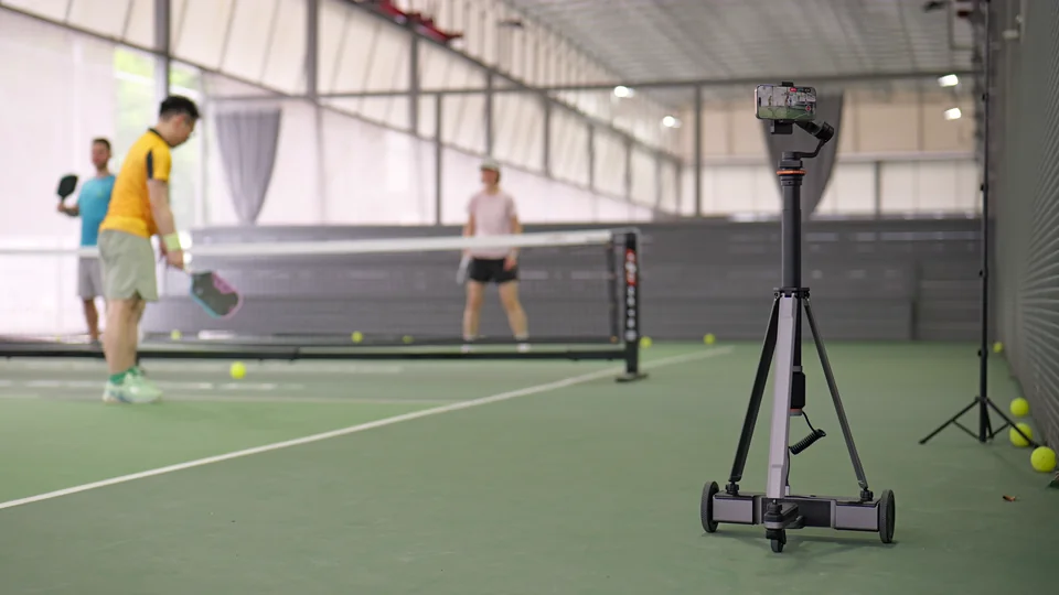 Tribot filming a pickleball rally with the robot in the foreground